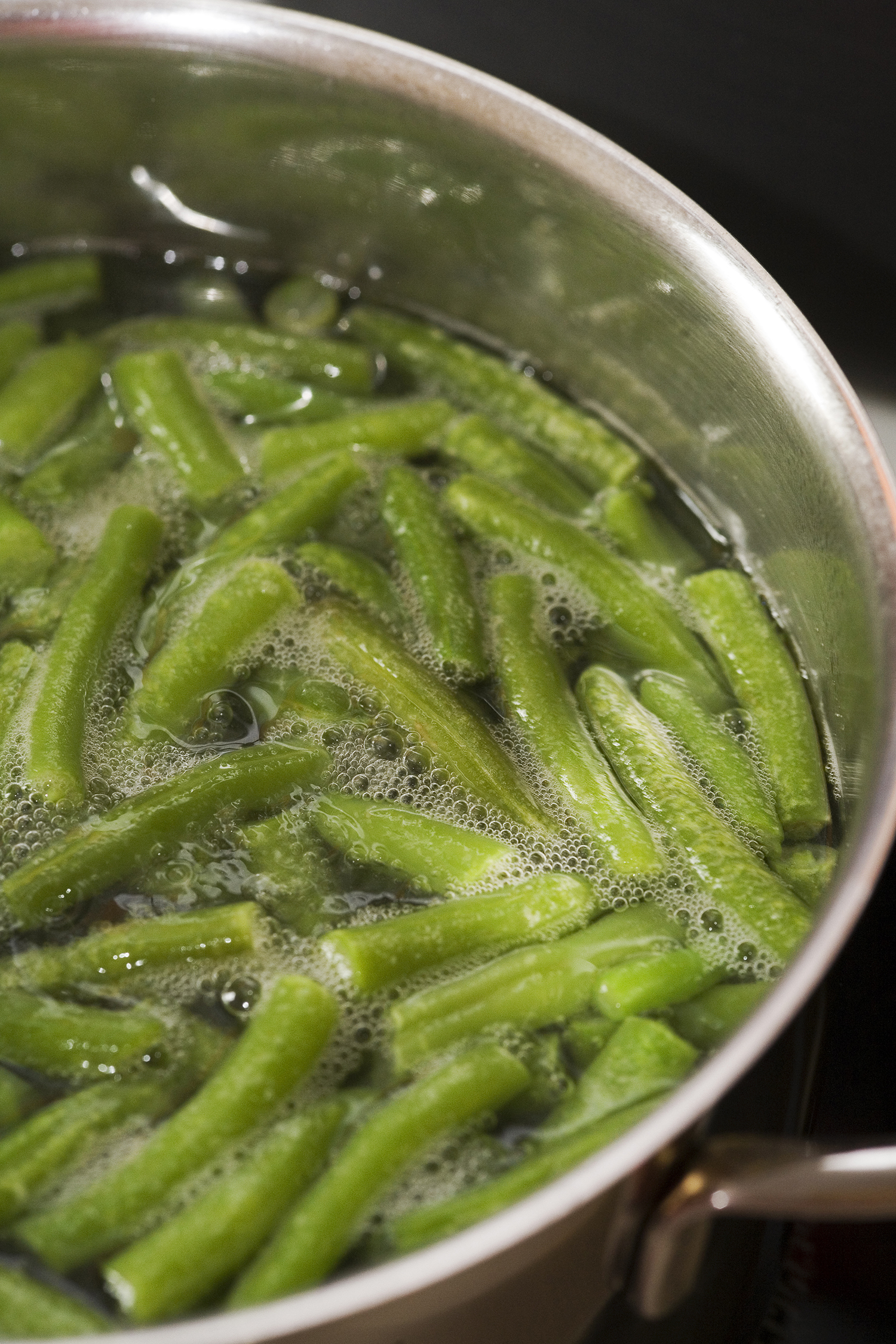 fresh green beans cooking in a pot