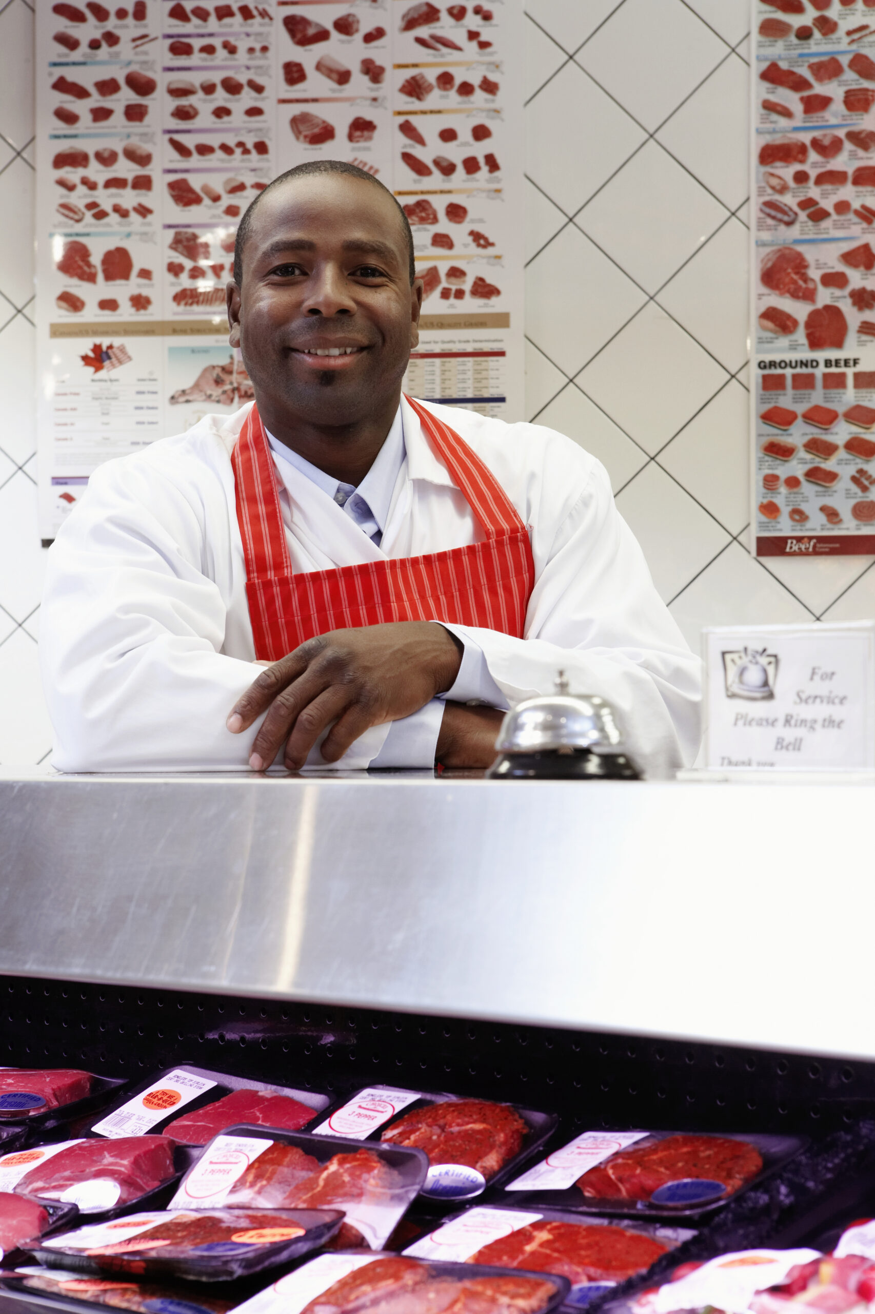 butcher behind the meat counter