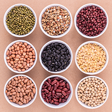 Mixed beans and lentils in white bowls