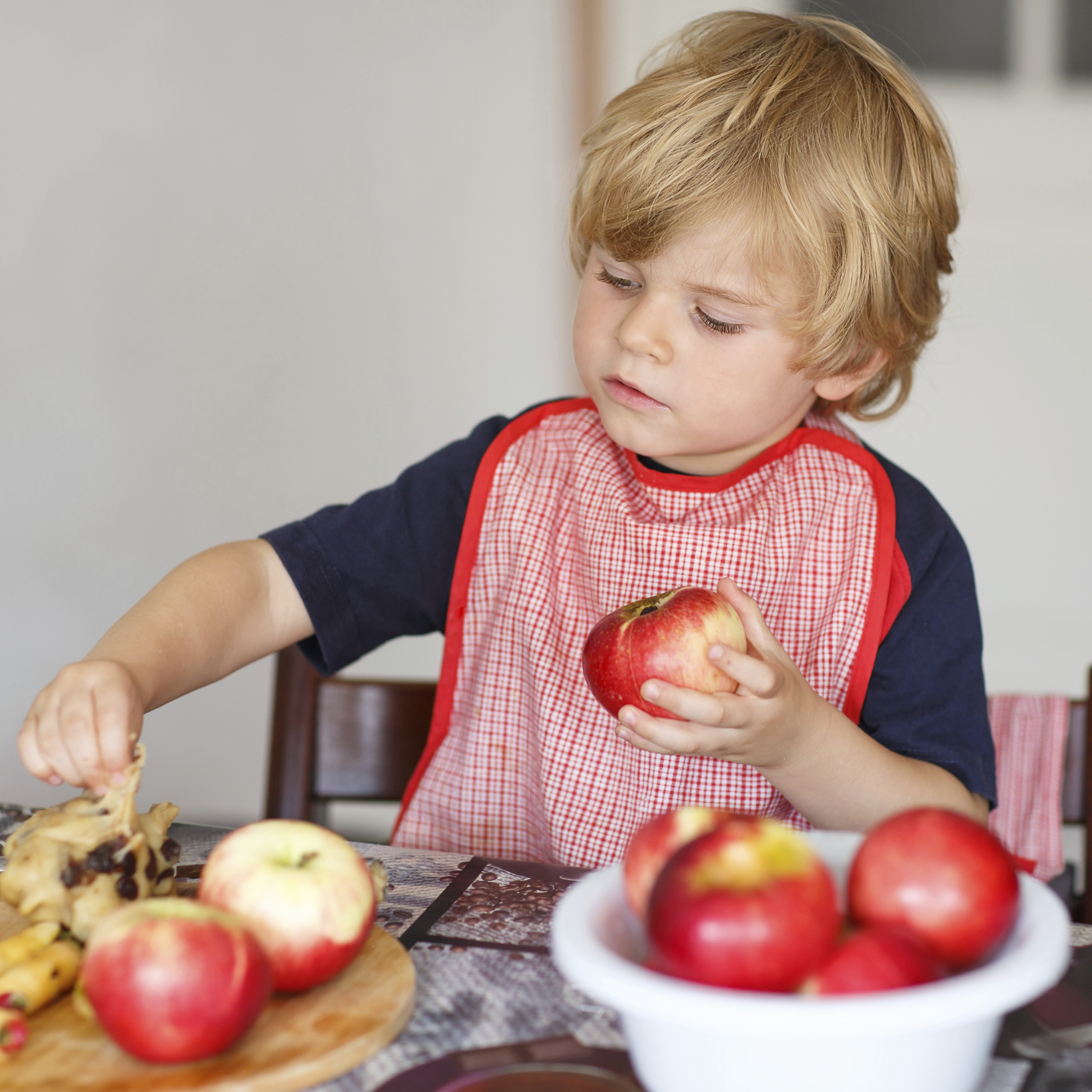 little boy holding an apple
